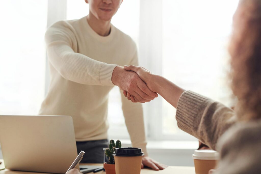 Mains serré entre deux individus dans un cadre lumineux